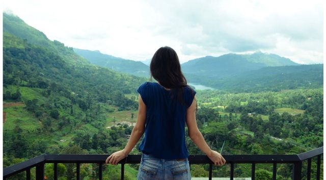 Born again Christian woman looking over a valley from deck