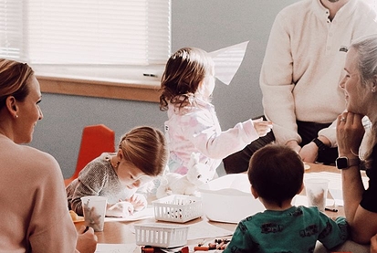 Kids doing crafts next to window