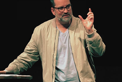 Pastor speaking on stage to audience