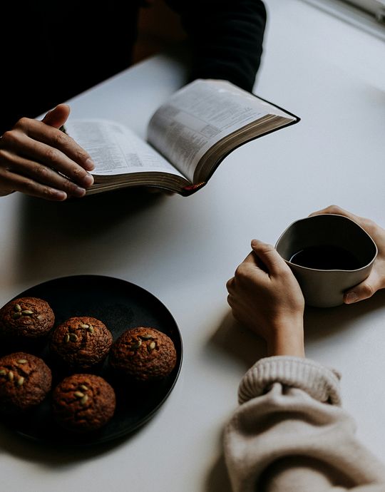 couple reading bible and drinking out of mug