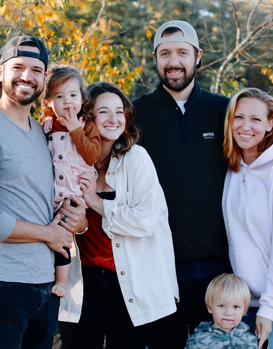 family of six smiling outisde