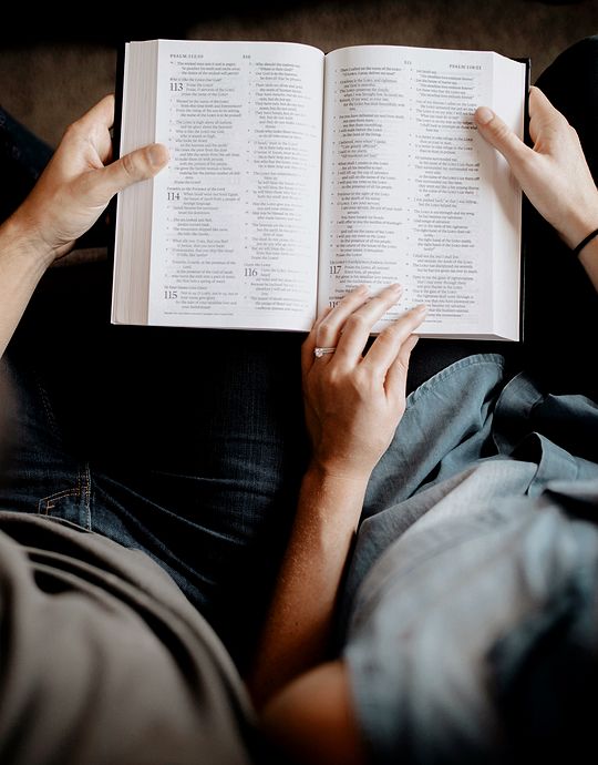 overhead view of couple reading bible together