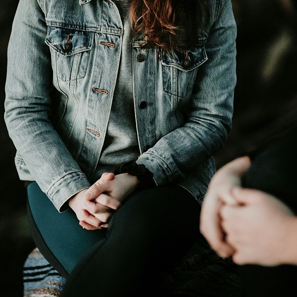 woman with hands clasped