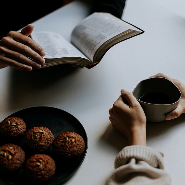 couple reading bible and drinking out of mug