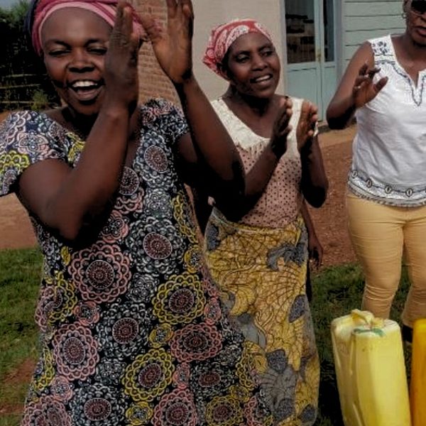 Women clapping and singing outside