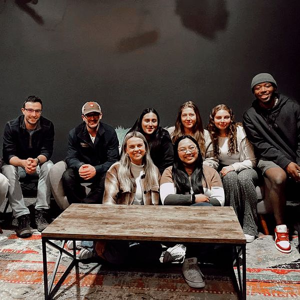 group photo of smiling young adults in doors