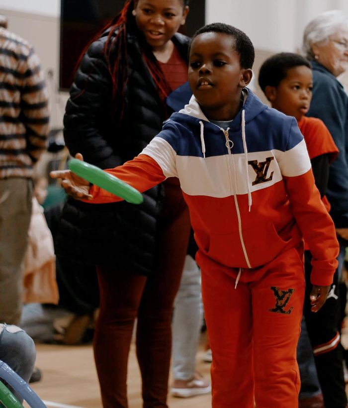 kid throwing frisbee at event