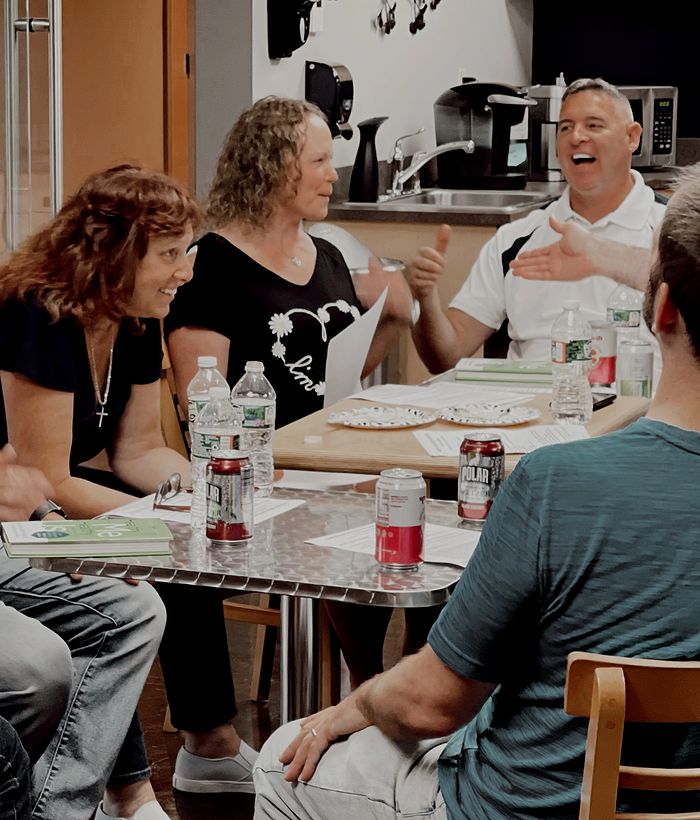 smiling group of married couples at table