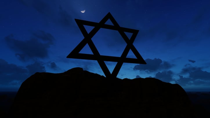 Star of David silhouette against a night sky with crescent moon