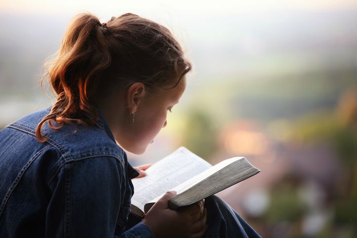 young girls reading passages from the bible