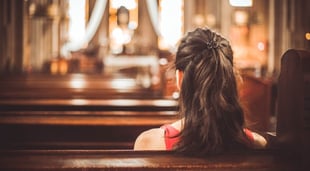 woman sitting in church pew