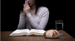 young woman fasting and praying